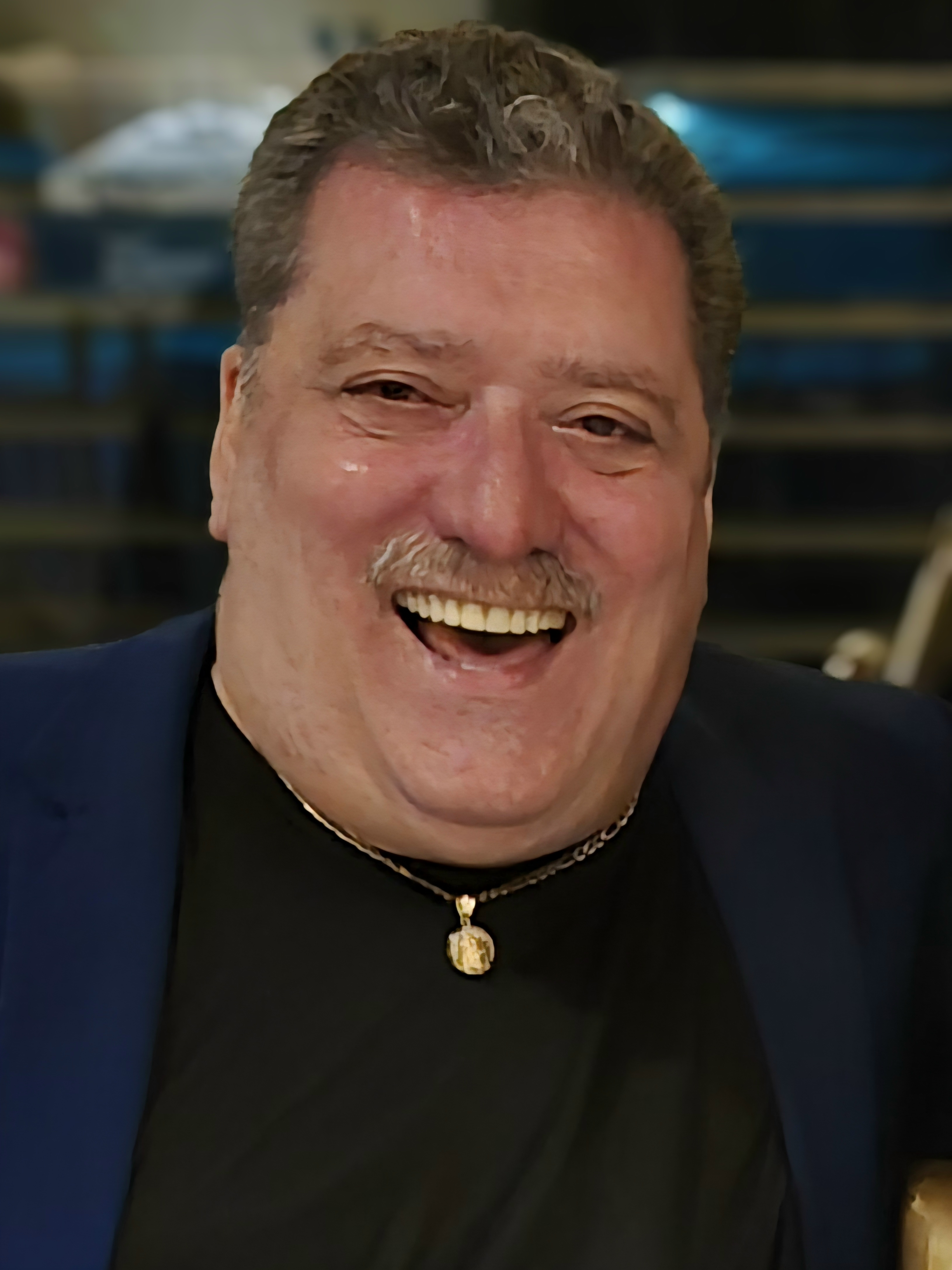 Jay Sands headshot, smiling, wearing a suit